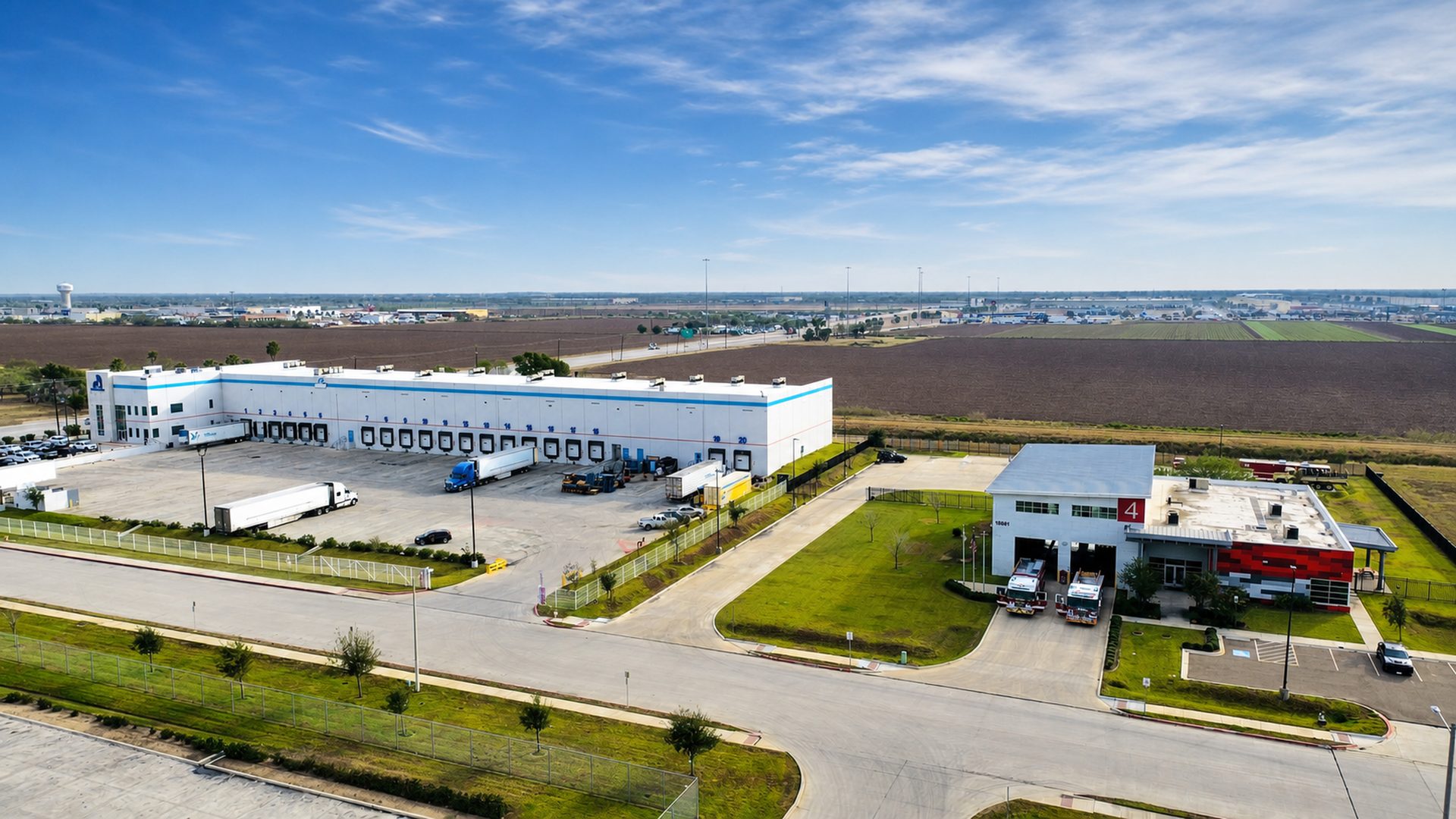 Wide aerial view of the Traveler Produce distribution campus and surrounding agricultural region