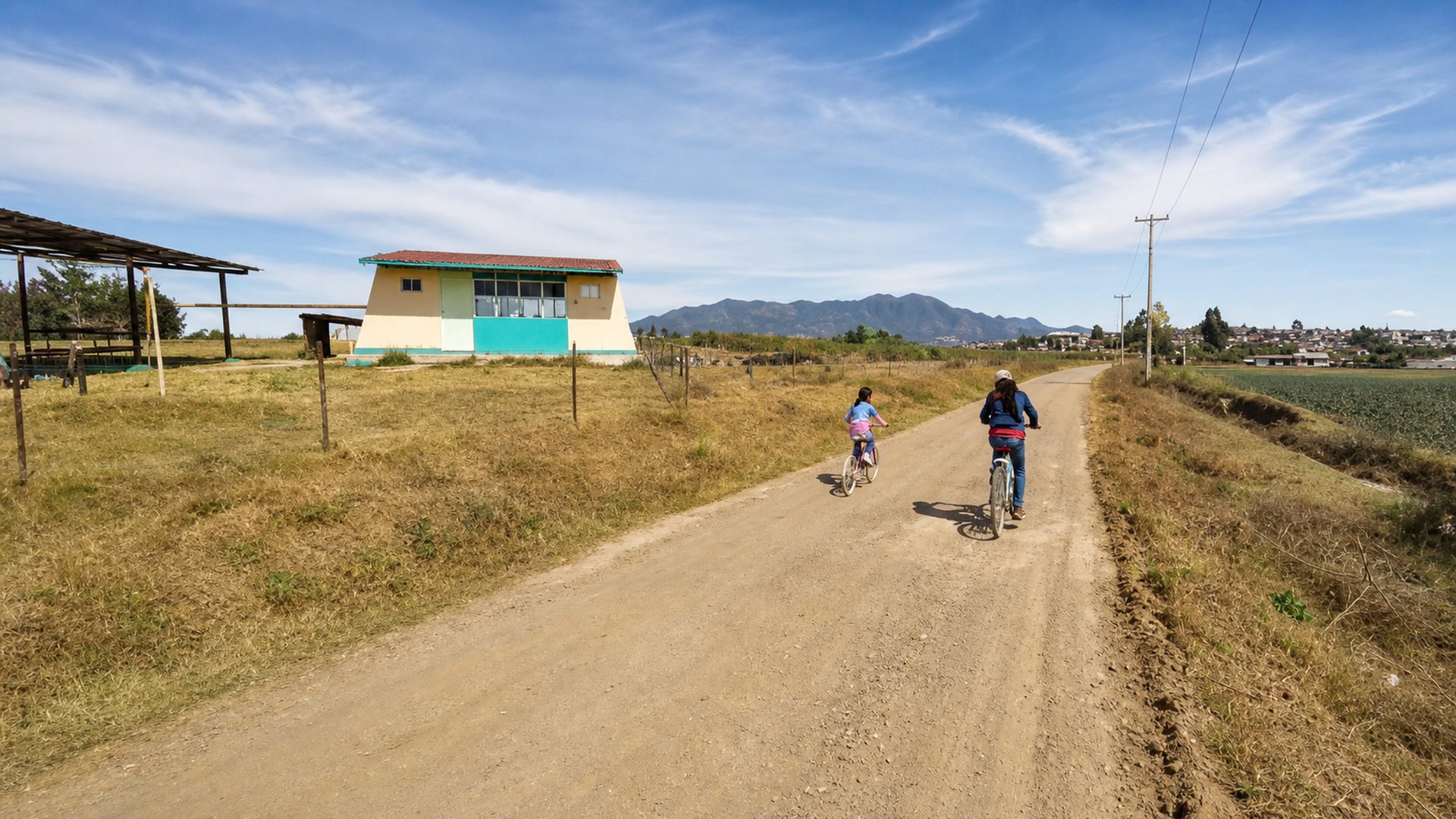 Children traveling by bicycle through a rural community